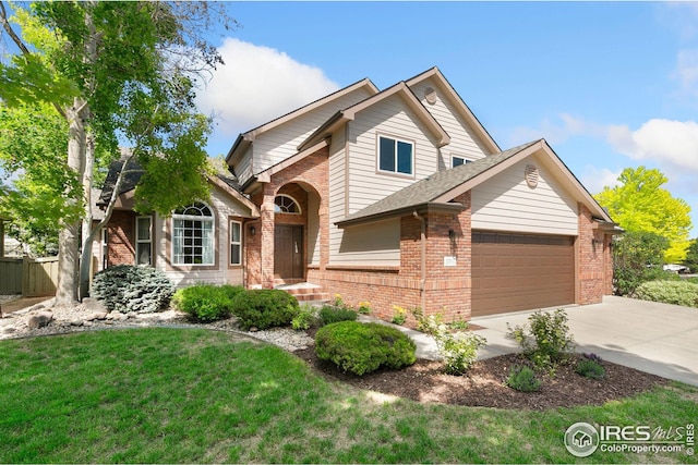3514 Copper Spring Dr, Fort Collins, CO 80528 - traditional-style home with brick siding, an attached garage, concrete driveway, and a front lawn