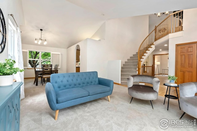 3514 Copper Spring Dr, Fort Collins, CO 80528 - carpeted living area featuring stairway, a chandelier, high vaulted ceiling, and arched walkways