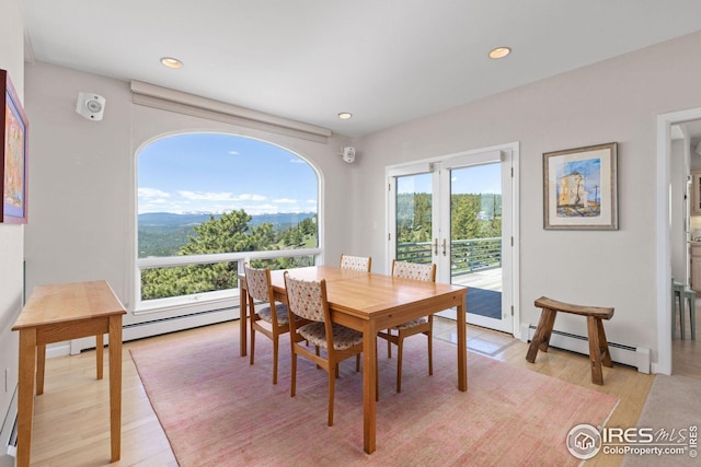 606 Sugarloaf Mountain Rd, Boulder, CO 80302 - dining room with a baseboard radiator, light wood-style flooring, recessed lighting, french doors, and a mountain view