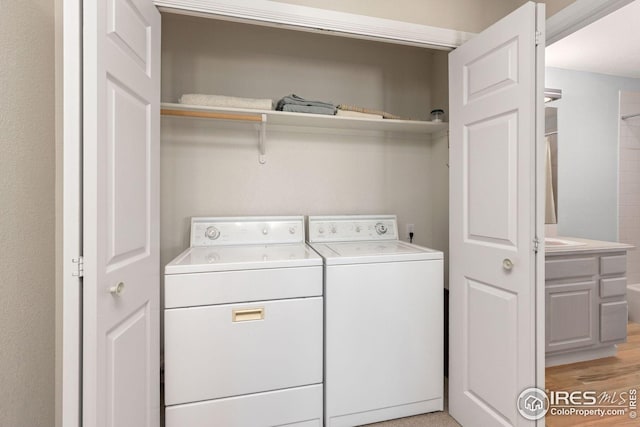 606 Sugarloaf Mountain Rd, Boulder, CO 80302 - washroom with washer and dryer and light wood-style floors