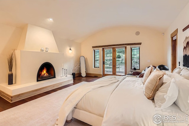 1570 County Road 37e, Lyons, CO 80540 - bedroom featuring lofted ceiling, access to outside, dark wood-type flooring, and a large fireplace