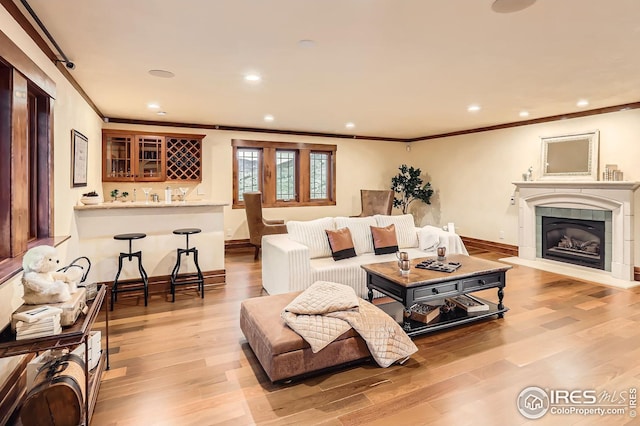 1570 County Road 37e, Lyons, CO 80540 - living area with crown molding, wet bar, light wood-type flooring, recessed lighting, and a tiled fireplace