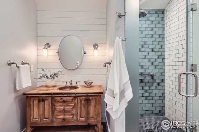 1570 County Road 37e, Lyons, CO 80540 - bathroom featuring a stall shower, vanity, and wood walls