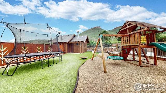 1570 County Road 37e, Lyons, CO 80540 - view of jungle gym with a trampoline, a fenced backyard, a storage shed, and a mountain view
