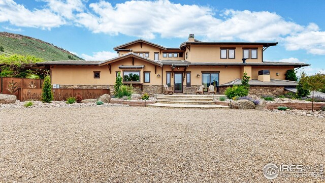 1570 County Road 37e, Lyons, CO 80540 - rear view of property with stucco siding and stone siding