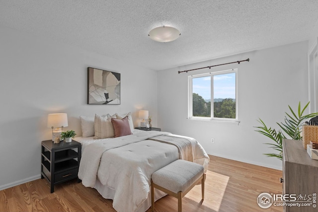 2037 Spencer St, Longmont, CO 80501 - bedroom featuring a textured ceiling and wood finished floors