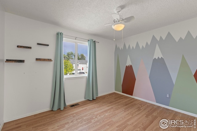 2037 Spencer St, Longmont, CO 80501 - empty room with wood finished floors, a textured ceiling, and a ceiling fan