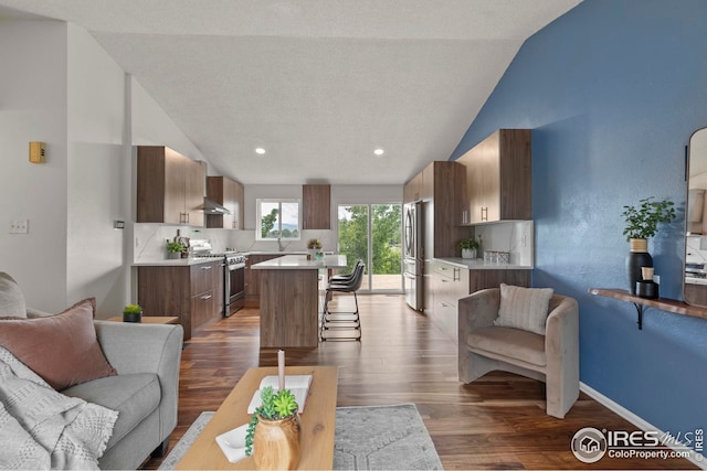 2037 Spencer St, Longmont, CO 80501 - living room featuring dark wood-type flooring, high vaulted ceiling, and recessed lighting
