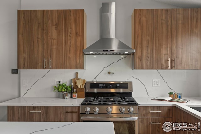 2037 Spencer St, Longmont, CO 80501 - kitchen with wall chimney range hood, modern cabinets, stainless steel range with gas stovetop, and decorative backsplash
