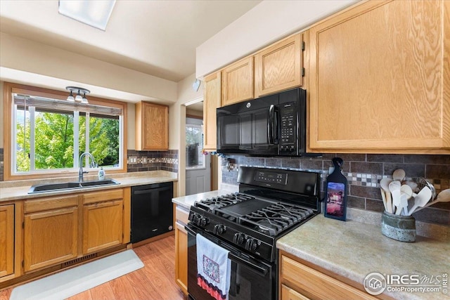 602 S 9th St, Berthoud, CO 80513 - kitchen with black appliances, light countertops, decorative backsplash, and light wood-style floors