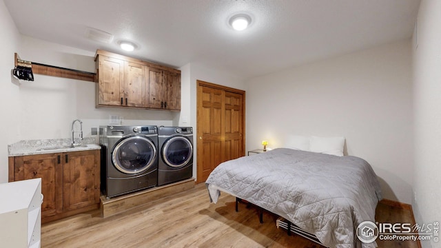 2029 Uplands Cir, Estes Park, CO 80517 - bedroom featuring separate washer and dryer and light wood finished floors