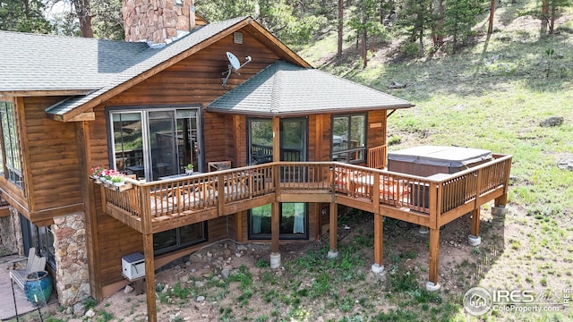 2029 Uplands Cir, Estes Park, CO 80517 - back of property featuring roof with shingles, a hot tub, a chimney, and a deck