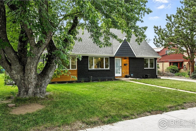 4545 Martin Dr, Boulder, CO 80305 - view of front facade featuring a shingled roof, brick siding, and a front lawn