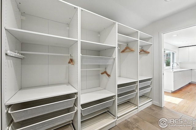 4545 Martin Dr, Boulder, CO 80305 - walk in closet with light wood-style floors and a sink