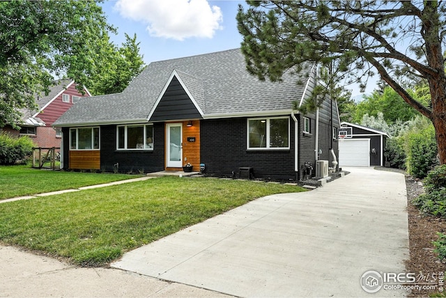 4545 Martin Dr, Boulder, CO 80305 - view of front of house featuring a shingled roof, an outdoor structure, a front lawn, a detached garage, and brick siding