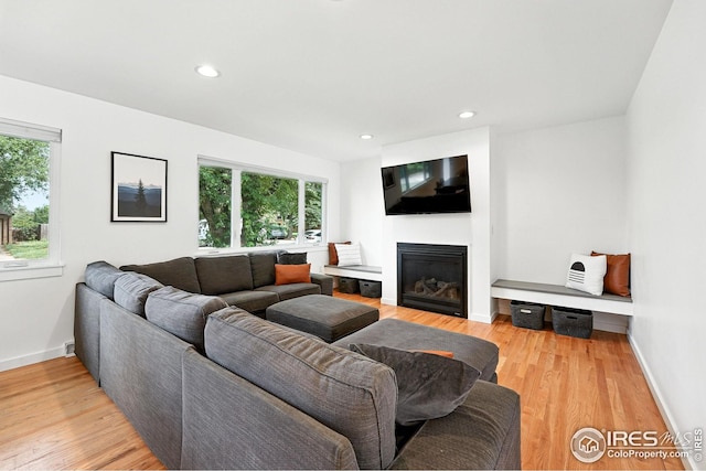 4545 Martin Dr, Boulder, CO 80305 - living area with plenty of natural light, a glass covered fireplace, light wood finished floors, and recessed lighting