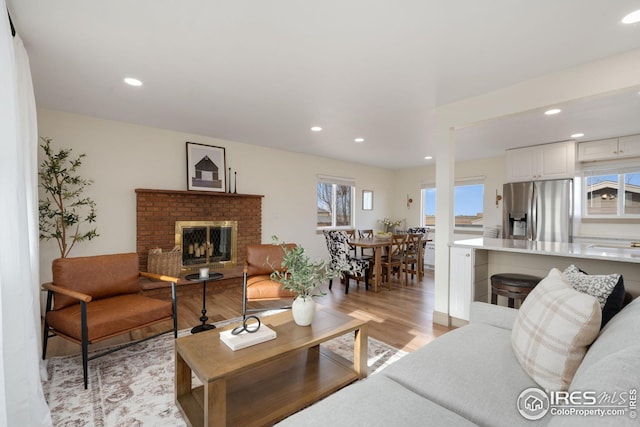 34288 County Road 59, Gill, CO 80624 - living room featuring light wood-type flooring, recessed lighting, and a brick fireplace