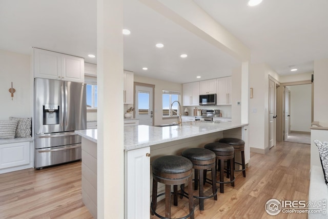 34288 County Road 59, Gill, CO 80624 - kitchen featuring stainless steel appliances, white cabinets, light wood-style floors, and recessed lighting