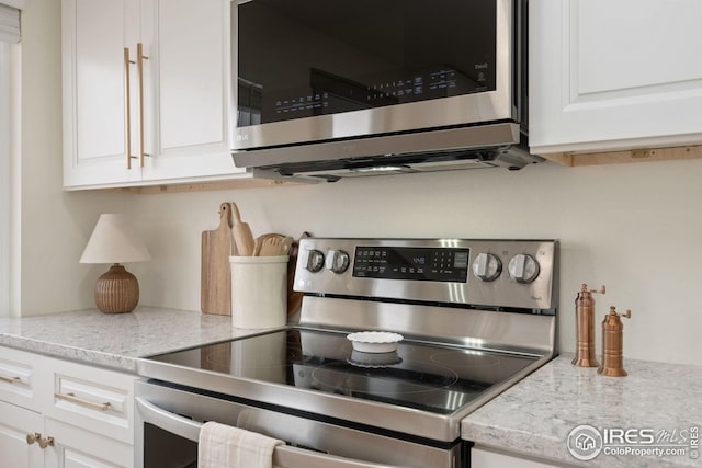 34288 County Road 59, Gill, CO 80624 - kitchen view of appliances with stainless steel finishes, white cabinets, and light stone counters