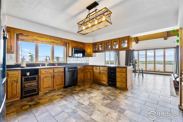 14975 US Highway 385, Julesburg, CO 80737 - kitchen featuring dishwasher, stainless steel microwave, brown cabinets, tasteful backsplash, and a textured ceiling