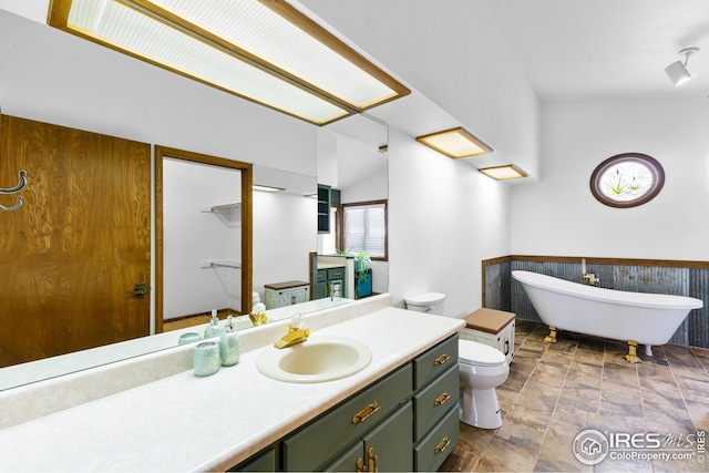 14975 US Highway 385, Julesburg, CO 80737 - full bathroom featuring a wainscoted wall, a freestanding bath, vanity, and stone finish flooring