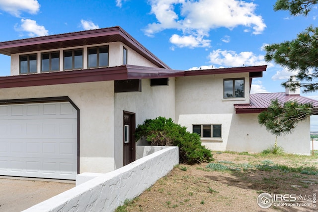 14975 US Highway 385, Julesburg, CO 80737 - view of front of house with stucco siding and a metal roof