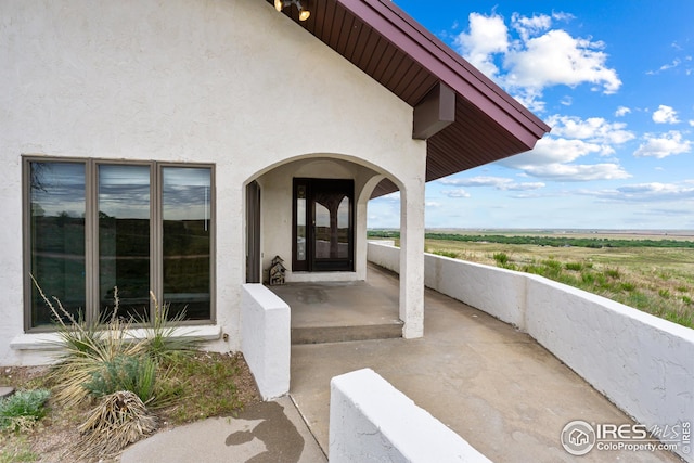 14975 US Highway 385, Julesburg, CO 80737 - view of exterior entry featuring stucco siding and a porch