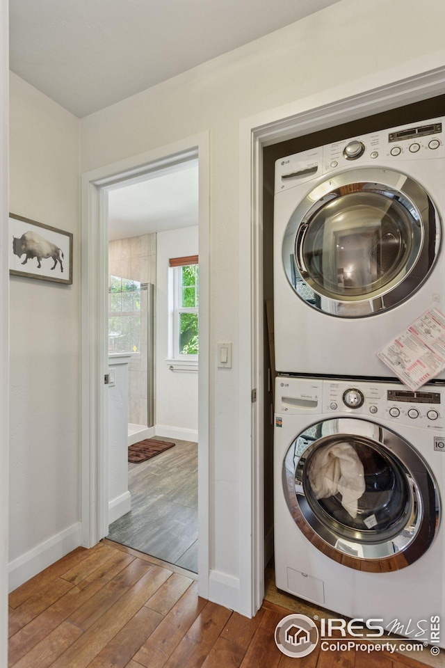 1944 Arapahoe Ave Unit A, Boulder, CO 80302 - laundry room featuring stacked washer and clothes dryer and hardwood / wood-style floors