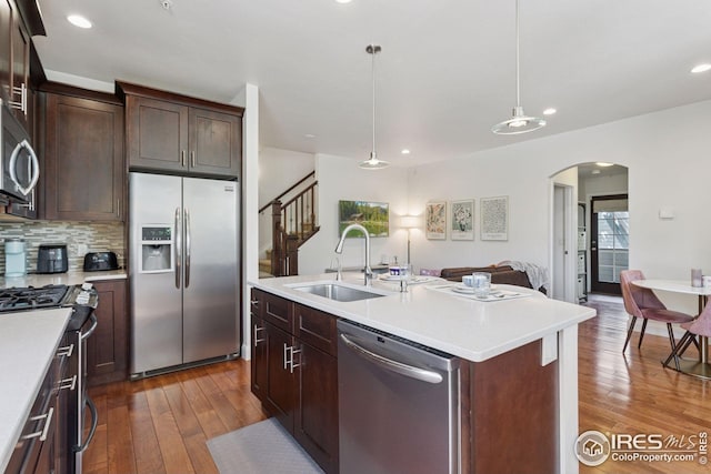 1944 Arapahoe Ave Unit A, Boulder, CO 80302 - kitchen with stainless steel appliances, arched walkways, dark wood-style flooring, light countertops, and open floor plan