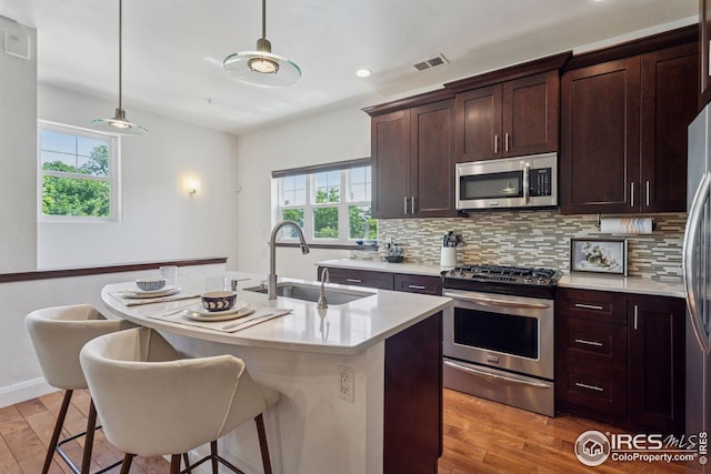 1944 Arapahoe Ave Unit A, Boulder, CO 80302 - kitchen featuring stainless steel appliances, plenty of natural light, tasteful backsplash, light wood-style floors, and recessed lighting