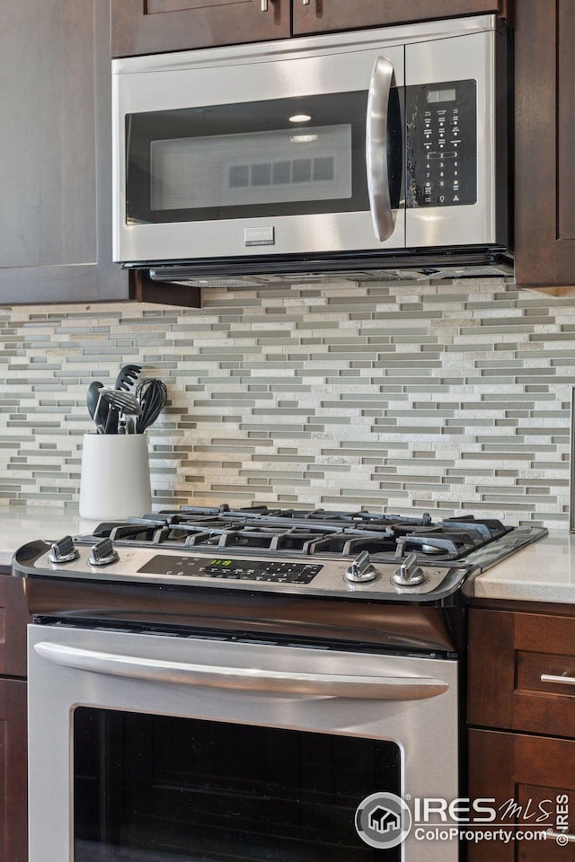 1944 Arapahoe Ave Unit A, Boulder, CO 80302 - kitchen view of appliances with stainless steel finishes, decorative backsplash, dark brown cabinetry, and light countertops
