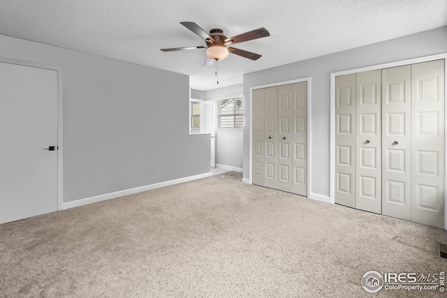 7414 Benton St, Arvada, CO 80003 - unfurnished bedroom with two closets, carpet, ceiling fan, and a textured ceiling