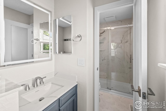 7414 Benton St, Arvada, CO 80003 - bathroom with vanity and a marble finish shower