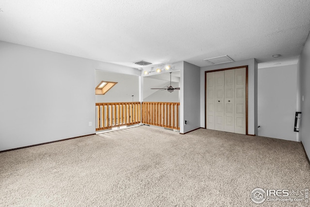 7414 Benton St, Arvada, CO 80003 - empty room featuring carpet floors, a ceiling fan, a textured ceiling, and attic access