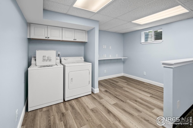 7414 Benton St, Arvada, CO 80003 - laundry area with washing machine and clothes dryer, light wood finished floors, and cabinet space