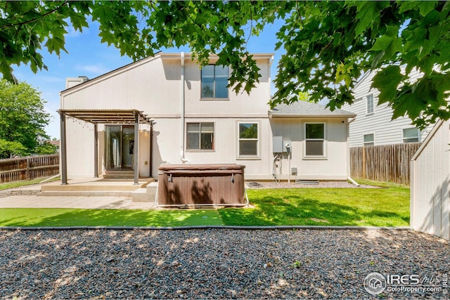 7414 Benton St, Arvada, CO 80003 - rear view of house featuring a hot tub, a patio, and a fenced backyard