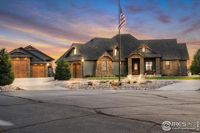 37021 Kingfisher Ct, Severance, CO 80550 - view of front of home featuring driveway, stone siding, brick siding, and a shingled roof
