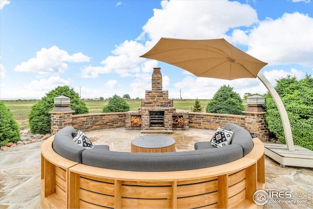 37021 Kingfisher Ct, Severance, CO 80550 - view of patio featuring an outdoor brick fireplace