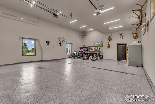 37021 Kingfisher Ct, Severance, CO 80550 - garage with freestanding refrigerator and a garage door opener