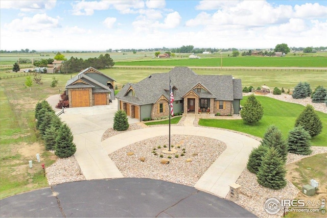 37021 Kingfisher Ct, Severance, CO 80550 - view of front facade featuring curved driveway, a rural view, and stone siding