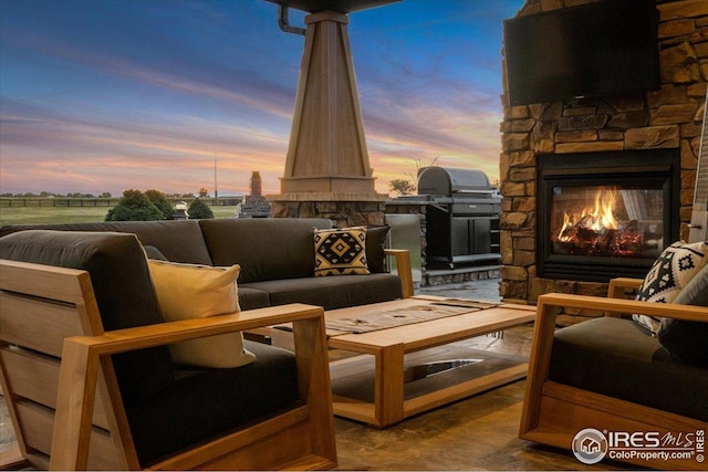 37021 Kingfisher Ct, Severance, CO 80550 - view of patio featuring an outdoor living space with a fireplace and area for grilling