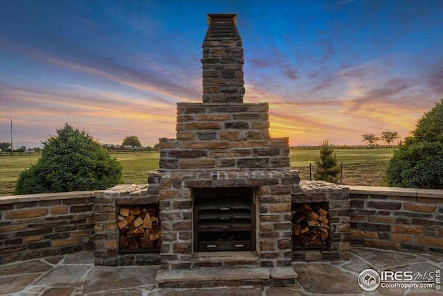 37021 Kingfisher Ct, Severance, CO 80550 - view of patio featuring exterior fireplace