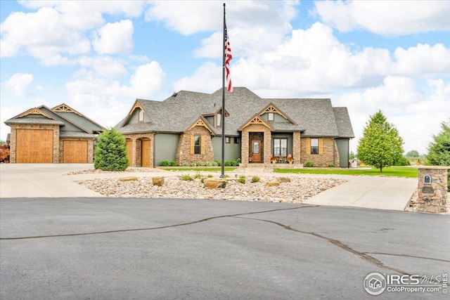 37021 Kingfisher Ct, Severance, CO 80550 - view of front of house with driveway, a shingled roof, and brick siding