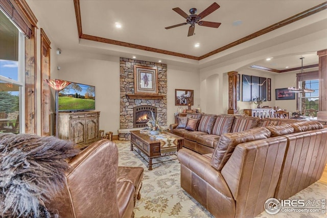 37021 Kingfisher Ct, Severance, CO 80550 - living area featuring a tray ceiling, ceiling fan, a fireplace, crown molding, and recessed lighting