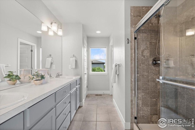 415 Stout St, Fort Collins, CO 80524 - bathroom with double vanity, a stall shower, tile patterned floors, and recessed lighting