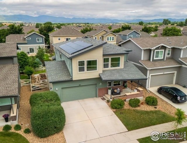 415 Stout St, Fort Collins, CO 80524 - view of front of property with an attached garage, a residential view, concrete driveway, and solar panels
