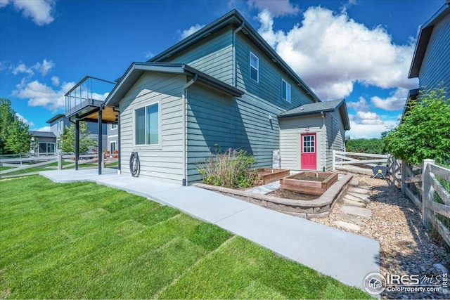 415 Stout St, Fort Collins, CO 80524 - rear view of property featuring a garden and a patio area