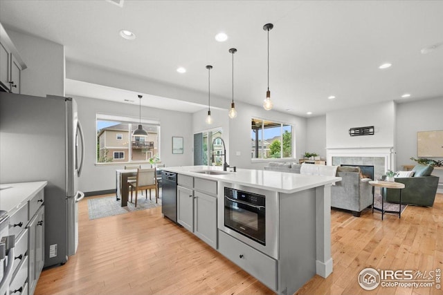 415 Stout St, Fort Collins, CO 80524 - kitchen with gray cabinetry, black dishwasher, light countertops, freestanding refrigerator, and recessed lighting