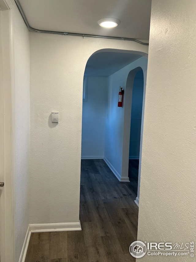 351 E 2nd St, Akron, CO 80720 - corridor featuring arched walkways and dark wood finished floors