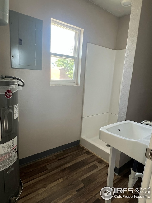 351 E 2nd St, Akron, CO 80720 - full bath featuring electric panel, water heater, wood finished floors, and a shower